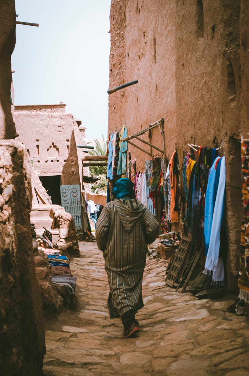 photo of a woman passing through the alley