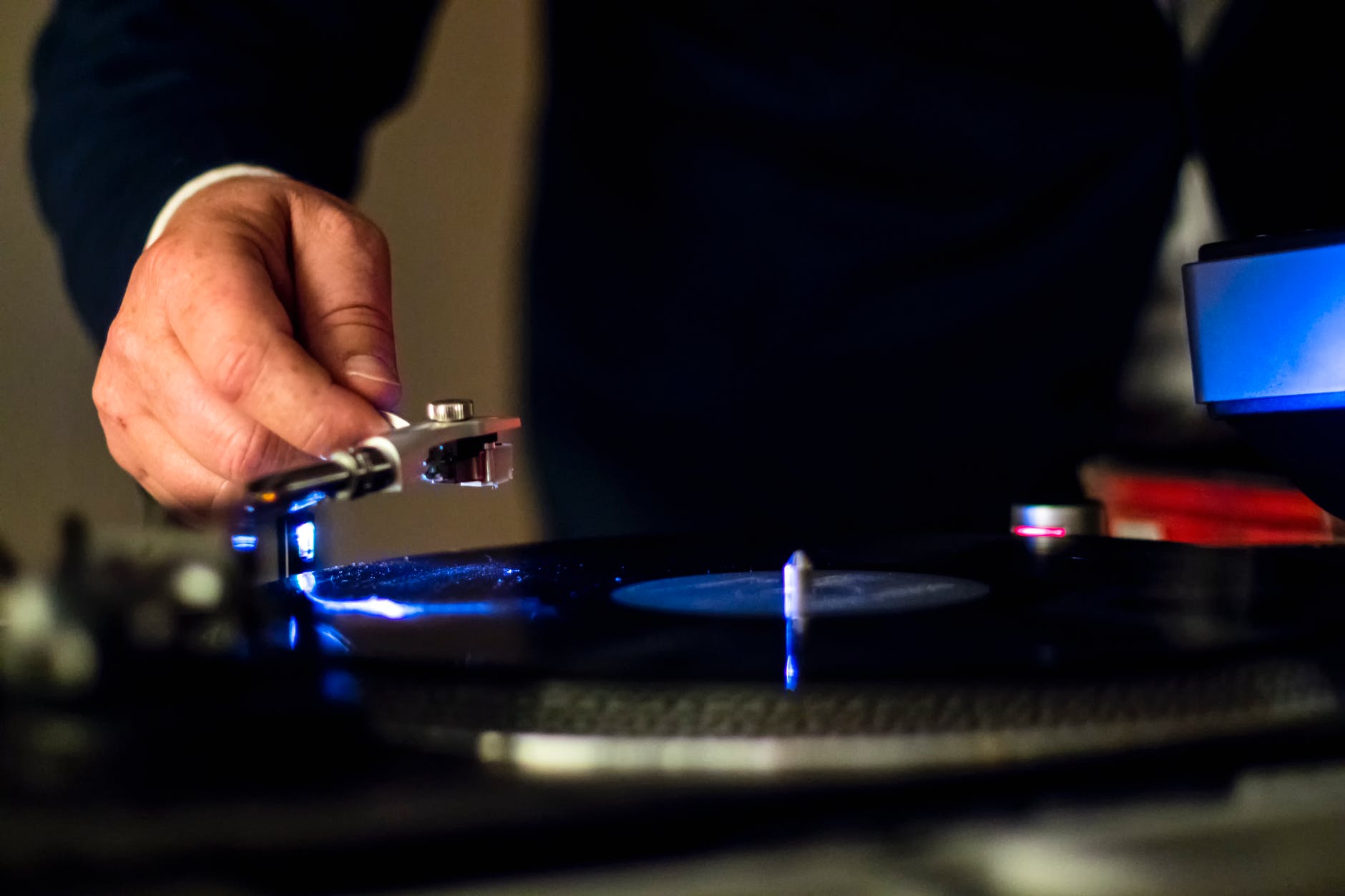 person holding vinyl player in shallow focus photography
